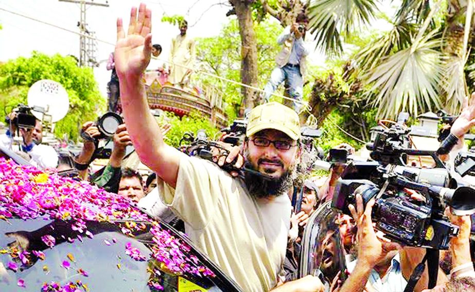 The son of former Pakistani premier Yousaf Raza Gilani, Ali Haider Gilani, waves as he arrives home in Lahore.