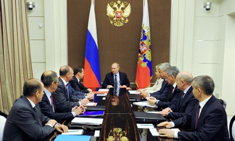 Russian President Vladimir Putin chairs a meeting with members of the Security Council at the Bocharov Ruchei state residence in Sochi on Friday.