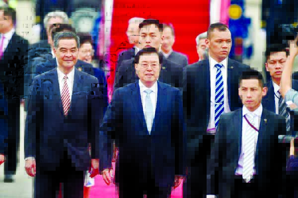 China's National People's Congress Standing Committee Chairman Zhang Dejiang Â© walks with Hong Kong Chief Executive Leung Chun-ying (L) after arriving at Hong Kong's International Airport.