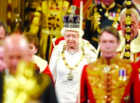 Britain's Queen Elizabeth proceeds through the Royal Gallery before the State Opening of Parliament in the House of Lords, at the Palace of Westminster in London on Wednesday.