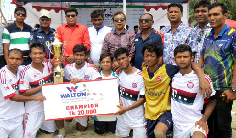 Members of Shatadal Club, the champions of the Walton 3rd Cox's Bazar Beach Football Tournament with the guests and the officials of Cox's Bazar District Sports Association pose for a photo session at the Laboni Point in Cox's Bazar Sea Beach on Wednes