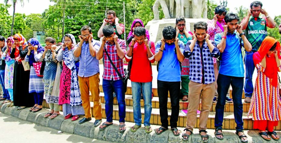 Students of different educational institutions formed a human chain holding their ears in front of Raju Sculpture on Dhaka University campus on Thursday in protest against humiliation on Shyamal Kanti Bhakta, Headmaster of Piyar Sattar Latif High School,
