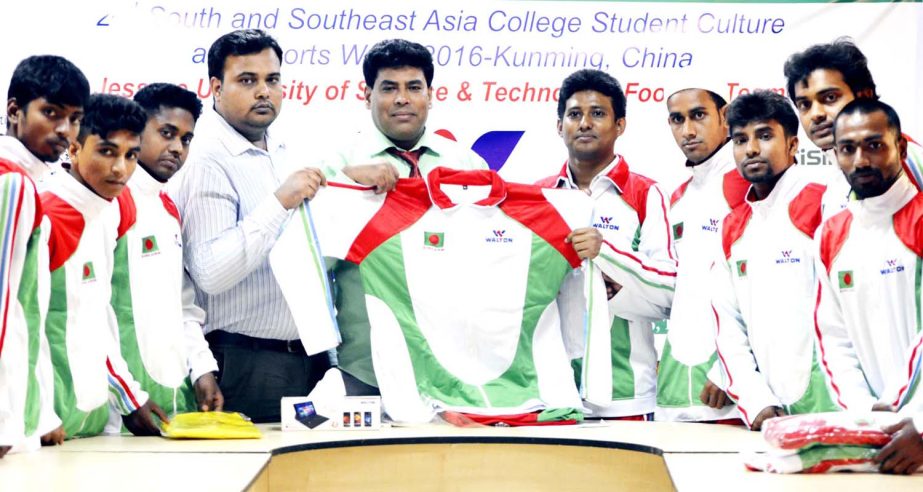 Senior Additional Director of Walton Group FM Iqbal Bin Anwar Dawn giving away jersey to the members of Jessore University of Engineering and Technology Football team at the conference room of Bangabandhu National Stadium on Thursday.