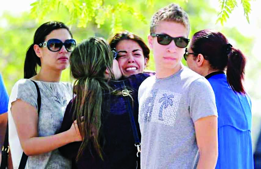Unidentified relatives and friends of passengers who were flying in an EgyptAir plane that vanished from radar en route from Paris to Cairo react as they wait outside the Egyptair in-flight service building where relatives are being held at Cairo Internat
