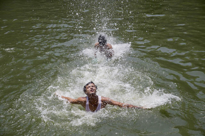 Indian boys swim at Hazrat Nizamuddin Baoli, a stepwell, on a hot day in New Delhi, India on Thursday.