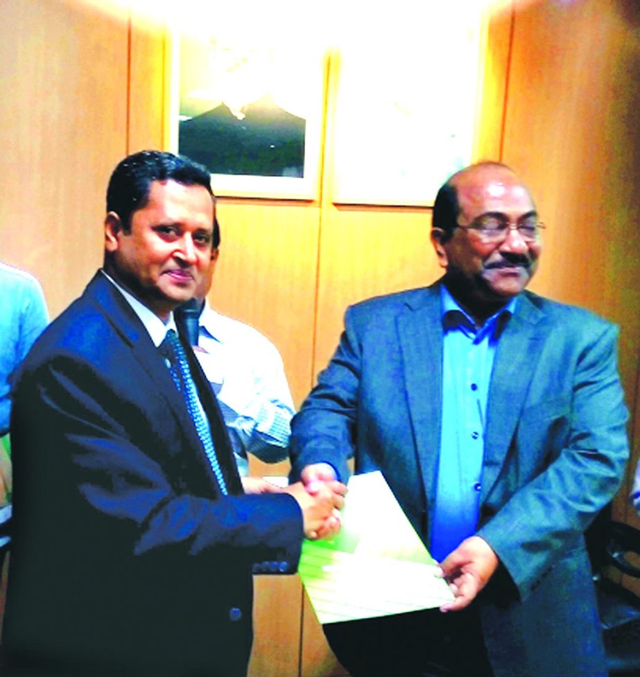Bangladesh Bank Deputy Governor Mr. S.K. Sur Chowdhury hands over a "Letter Of Appreciation"" to The Uttara Bank Limited for achieving disbursement of Agricultural lending target for the financial year 2014-2015 by Bangladesh Bank in a program recently."