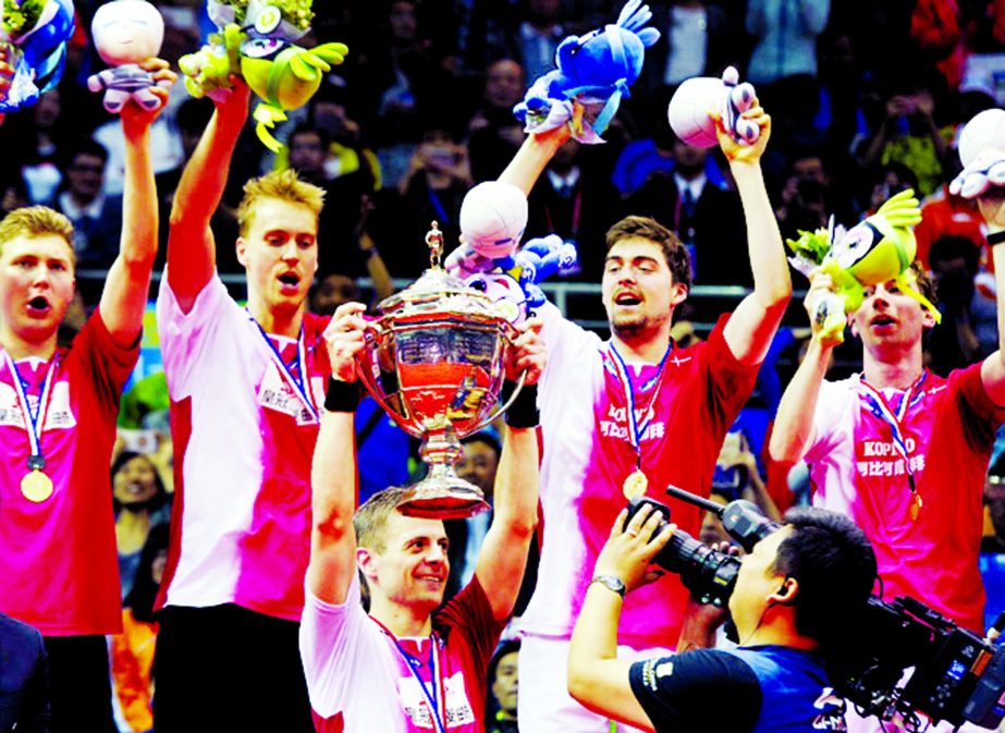 Denmark's players celebrate with the trophy and medals during the award ceremony after they won in their men's final group match against Indonesia in the Thomas Cup badminton tournament in Kunshan in east China's Jiangsu province on Sunday.