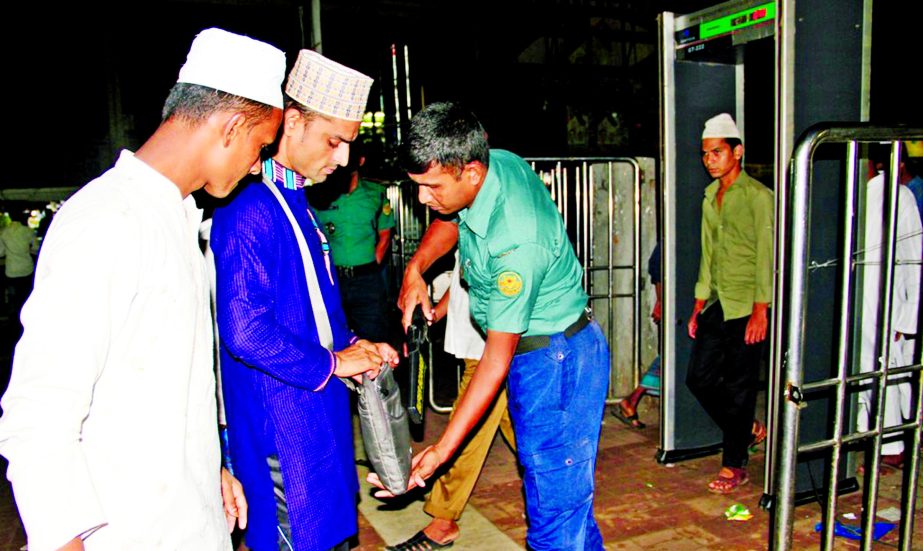 Police searching the bag of a devotee before entering the Baitul Mukarram National Mosque for offering prayers on Shab-e-barat night.