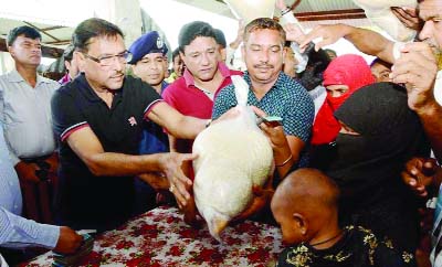 NOAKHALI: Road Transport and Bridges Minister Obaidul Quader distributing relief materials among victims of cyclone Roanu of coastal areas in Companyganj on Monday