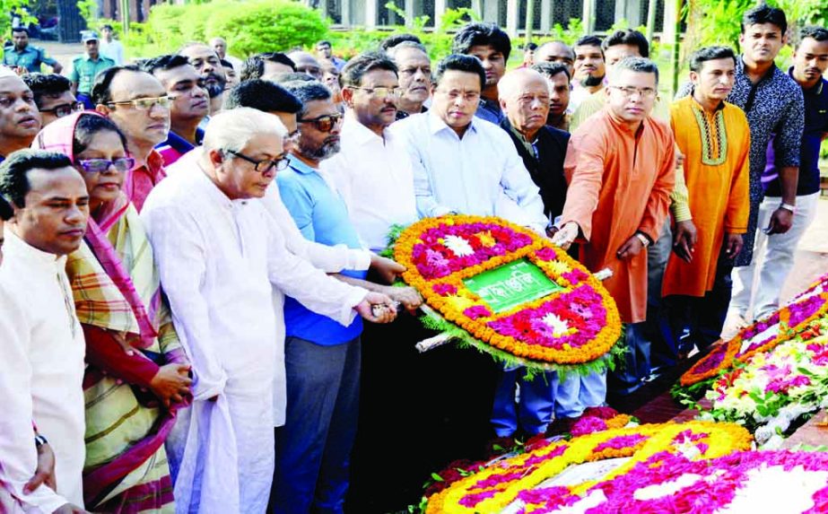 Roads, Transports and Bridges Ministaer Obaidul Quader along with party leaders and activists paying tributes to the National Poet Kazi Nazrul Islam by placing floral wreaths at his Mazar in the city on Wednesday marking 117th birth anniversary of the poe