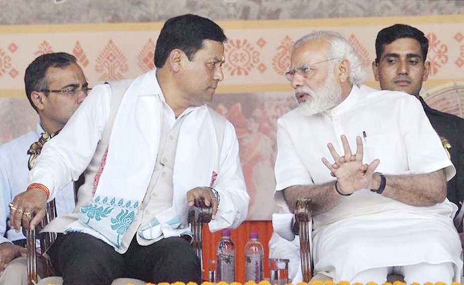 Prime Minister Narendra Modi with Sarbananda Sonowal during the swearimg-in ceremony in Guwahati on Tuesday.