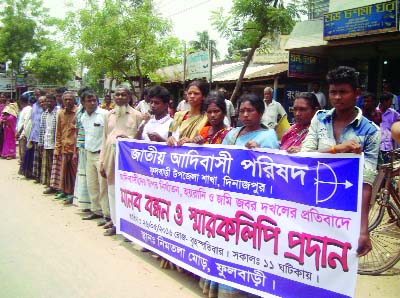 PHULBARI(Dinajpur): Jatiya Adivasi Parishad formed a human chain at Nimtola area in Phulbari on Thursday to realise 5- point demands including recovery of grabbed land and immediate arrest of the grabbers on Thursday.