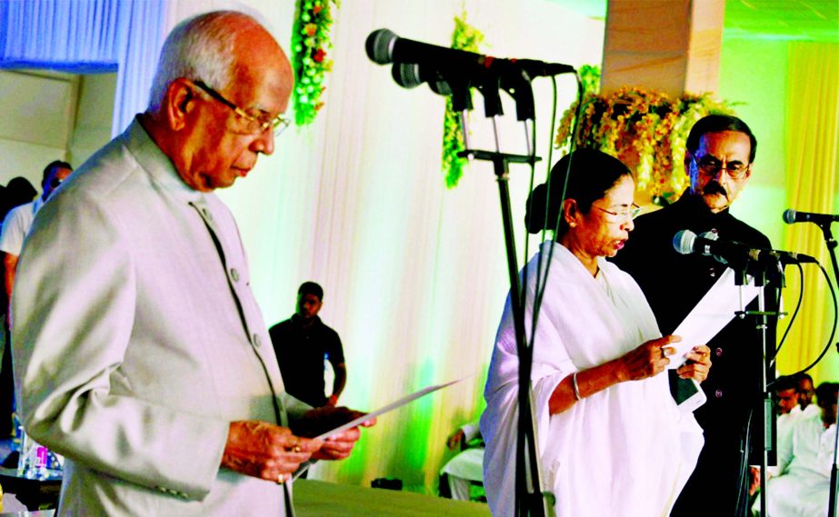Bengal Governor Keshari Nath Tripathy administers the oath of secrecy to West Bengal Chief Minister Mamata Banerjee during swearing-in ceremony in Kolkata on Friday.