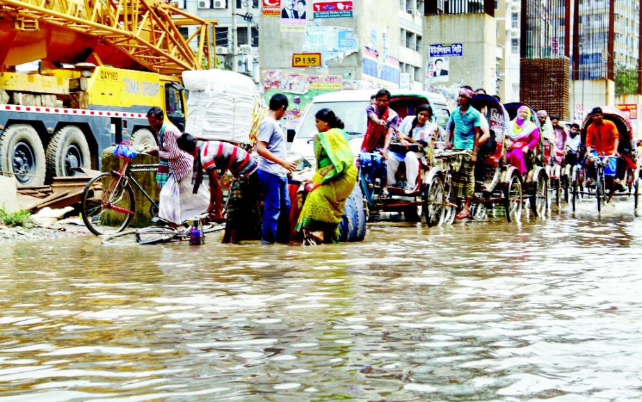 City experiences heavy rains on Saturday causing sufferings to pedestrians and commuters. This photo was taken from Malibagh-Shantinagar area.