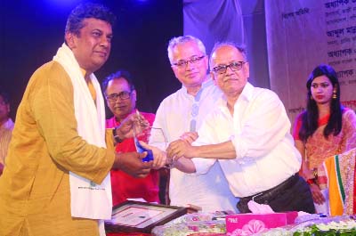TRISHAL (Mymensingh): Singer Khairul Anam receiving a crest for outstanding contributions on Nazrul songs from Prof Abdul Mannan, Chairman, University Grants Commission and Prof Dr Mohit- Ul- Alam, VC, National Poet Kazi Nazrul Islam University at
