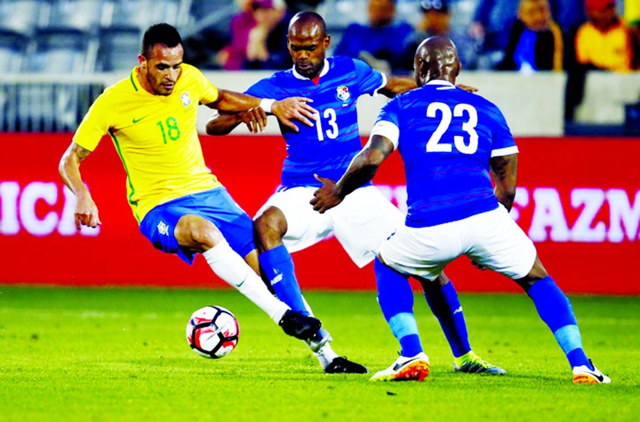 Brazil's Renato Augusto (left) works the ball down the pitch past Panama defenders Adolfo Machado (center,)and Felipe Baloy in the first half of an exhibition soccer match, which is part of the Chevrolet Brazil Global Tour, on Sunday in Commerce City, Co