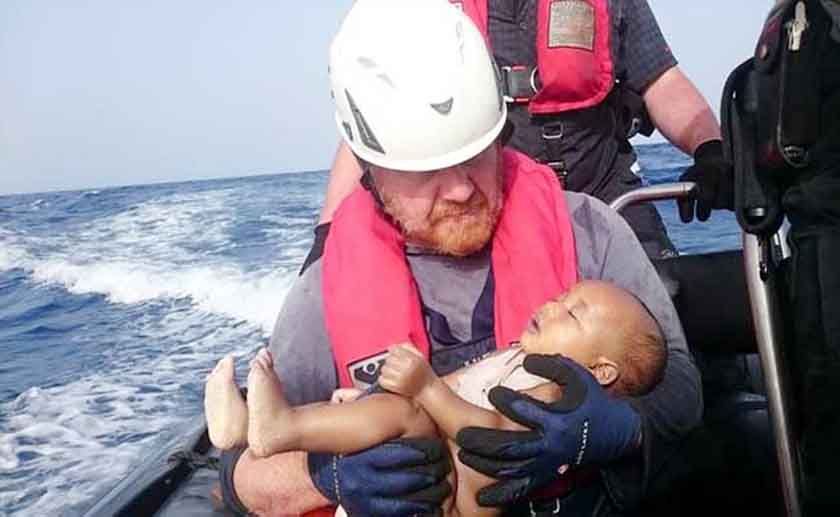 A German rescuer from the humanitarian organisation Sea-Watch holds a drowned migrant baby, off the Libyan coast on May 27. AP file photo