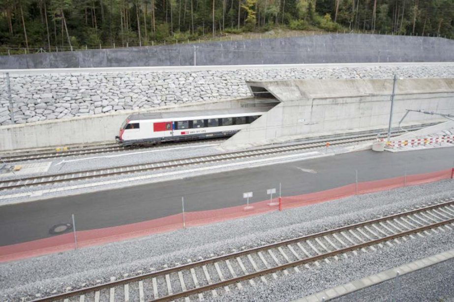 A train makes its way at the north entrance of the new Gotthard Base Tunnel the world's longest train tunnel on the eve of its opening ceremony on Tuesday in Erstfeld.