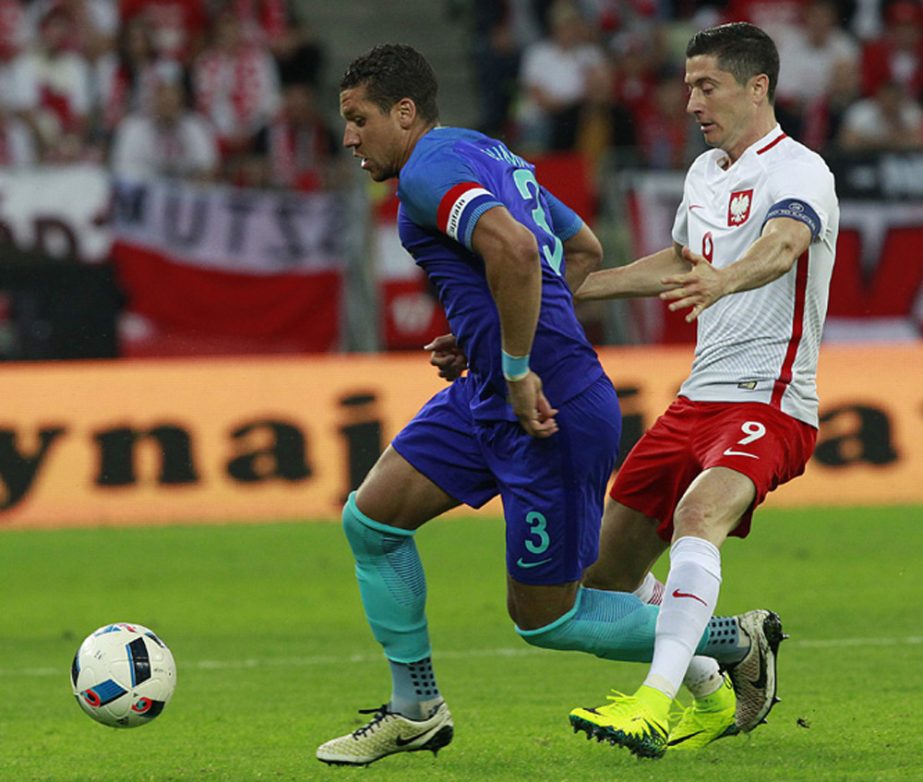 Robert Lewandowski of Poland (right) and Netherlands Virgil van Dijk challenge for the ball during a friendly soccer match between Poland and Netherlands in Gdansk, Poland on Wednesday.