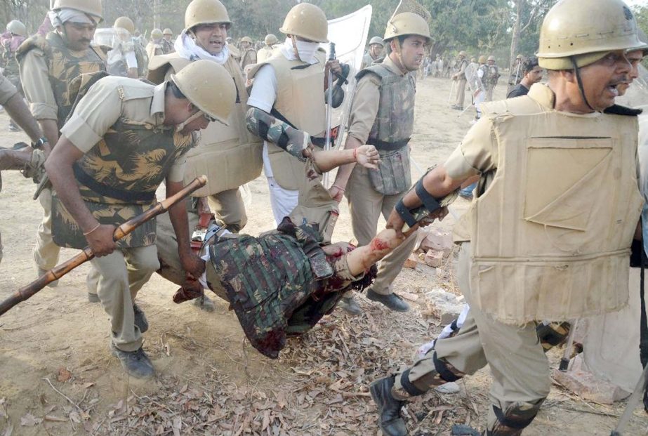 Indian police carry a colleague injured during clashes with members of a sect said to have been living illegally at the Jawahar Bagh park in Mathura on Thursday.