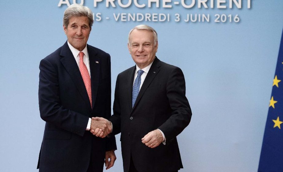 French Foreign minister Jean-Marc Ayrault (R) shakes hands with US Secretary of State John Kerry in Paris on Friday for talks on the Israeli-Palestinian conflict.