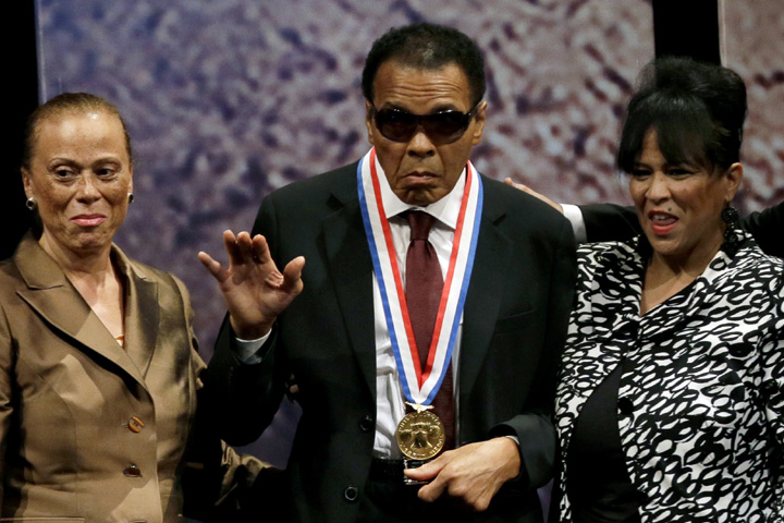 In this Sept. 13, 2012, file photo, retired boxing champion Muhammad Ali (center) waves alongside his wife Lonnie Ali (left) and his sister-in-law Marilyn Williams (right) after receiving the Liberty Medal during a ceremony at the National Constitution Ce