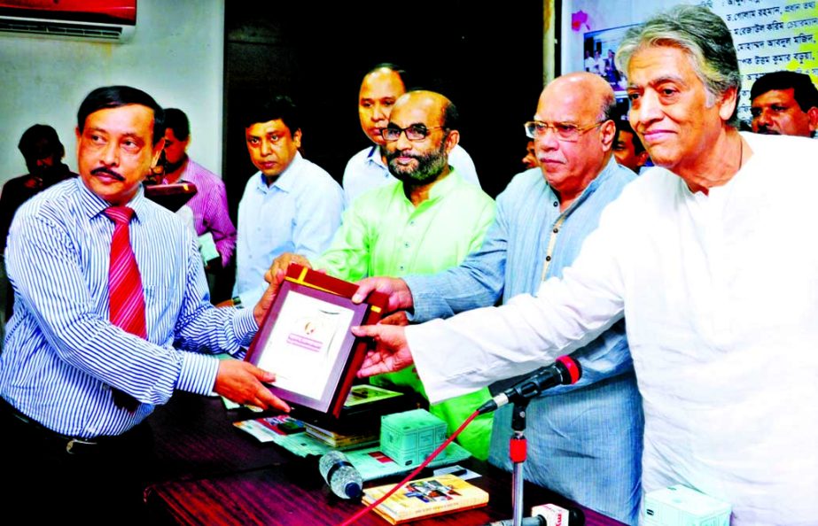 Health Minister Mohammad Nasim handing over Mother Teresa Trophy to Prof Md Farhad Hossain for his outstanding contributions in Child Health and social works at the Jatiya Press Club on Sunday.