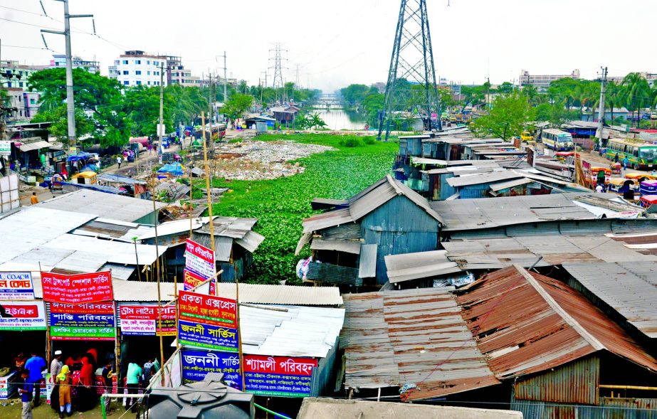 Occupying lands along rivers, canals and ditches by the influentials around the capital a regular phenomenon. Photo shows a portion of canal at Siddhirganj being occupied by constructing tinsheds near Chittagong Road. The photo was taken on Sunday.