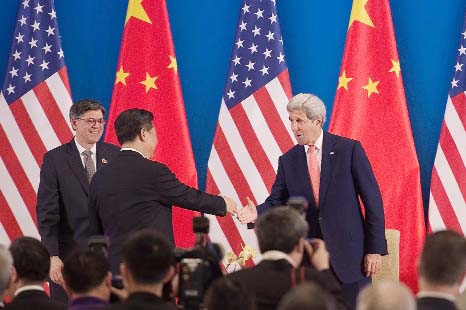 China's President Xi Jinping shaking hands with US Secretary of State John Kerry (R) as US Treasury Secretary Jacob Lew looks on during the opening session of the US - China Strategic and Economic Dialogues in Beijing on Monday.