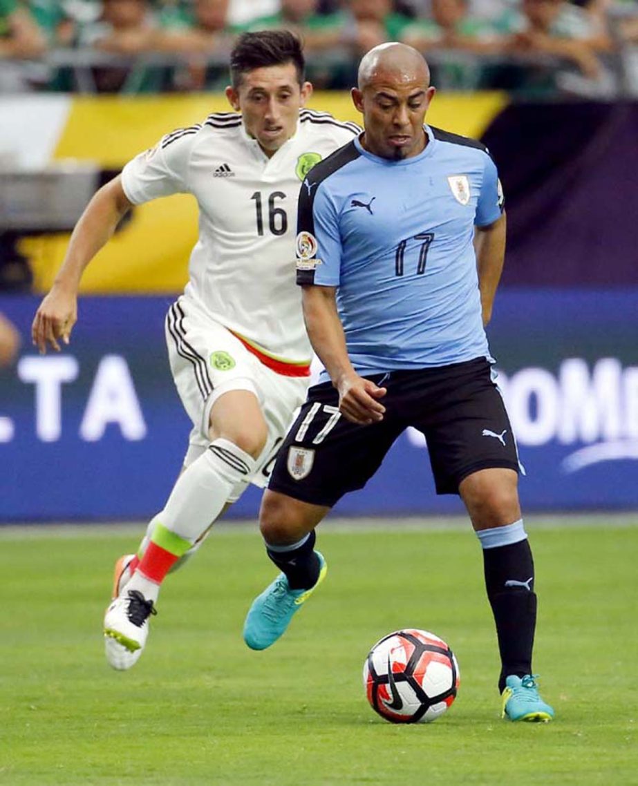 Uruguay midfielder Egidio Arevalo (17) and Mexico midfielder Hector Herrera (16) battle for the ball during the second half of a Copa America group C soccer match at University of Phoenix Stadium in Glendale, Ariz on Sunday.