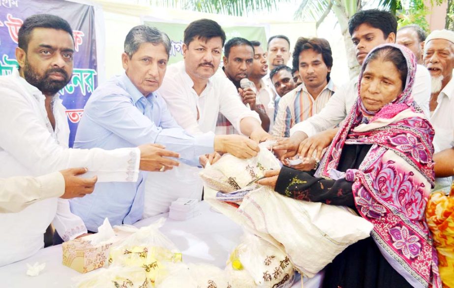 Chairman of Chittagong Development Authority Abdus Salam distributing Iftar commodities among the poor people of East Bakolia yesterday.