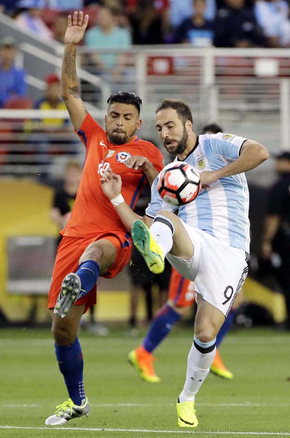 Argentinaâ€™s Gonzalo Higuain (right) and Chileâ€™s Gonzalo Jara fight for the ball during a Copa America Centenario Group A soccer match at Levi's Stadium in Santa Clara, Calif on Monday.