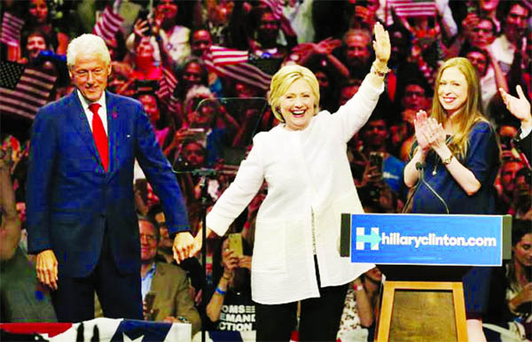 Democratic U.S. presidential candidate Hillary Clinton waves as she stands onstage with her husband former President Bill Clinton (L) and her daughter Chelsea Â® after speaking during her California primary night rally held in the Brooklyn borough of Ne