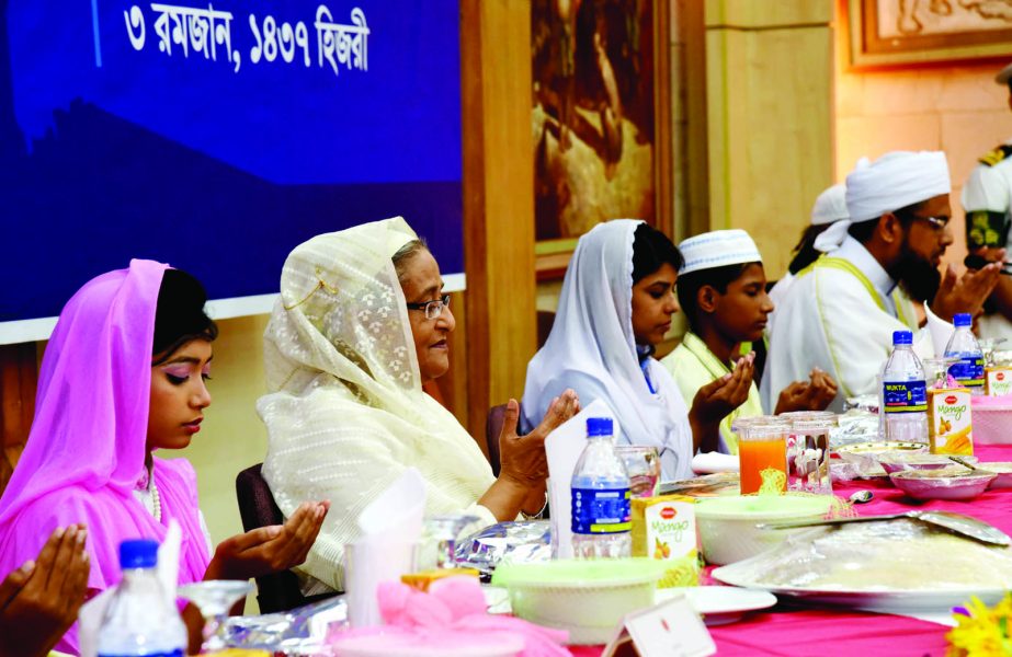 Prime Minister Sheikh Hasina along with others offering Munajat at an Iftar Mahfil organised for freedom fighters, disabled and orphans at Ganobhaban in the city on Thursday.