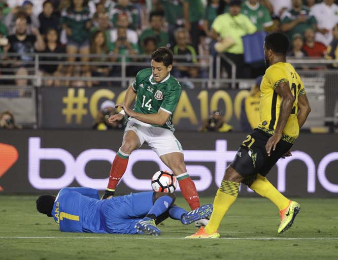 Jamaica goalkeeper Andre Blake (bottom) stops a shot by Mexico's Chicharito during the second half of a Copa America Centenario Group C soccer match at the Rose Bowl in Pasadena, Calif on Thursday.