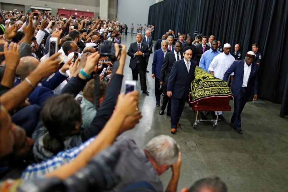 Well-wishers take photographs as the casket with the body of the late boxing champion Muhammad Ali is brought for his janazah, an Islamic funeral prayer, in Louisville, Kentucky on Thursday.