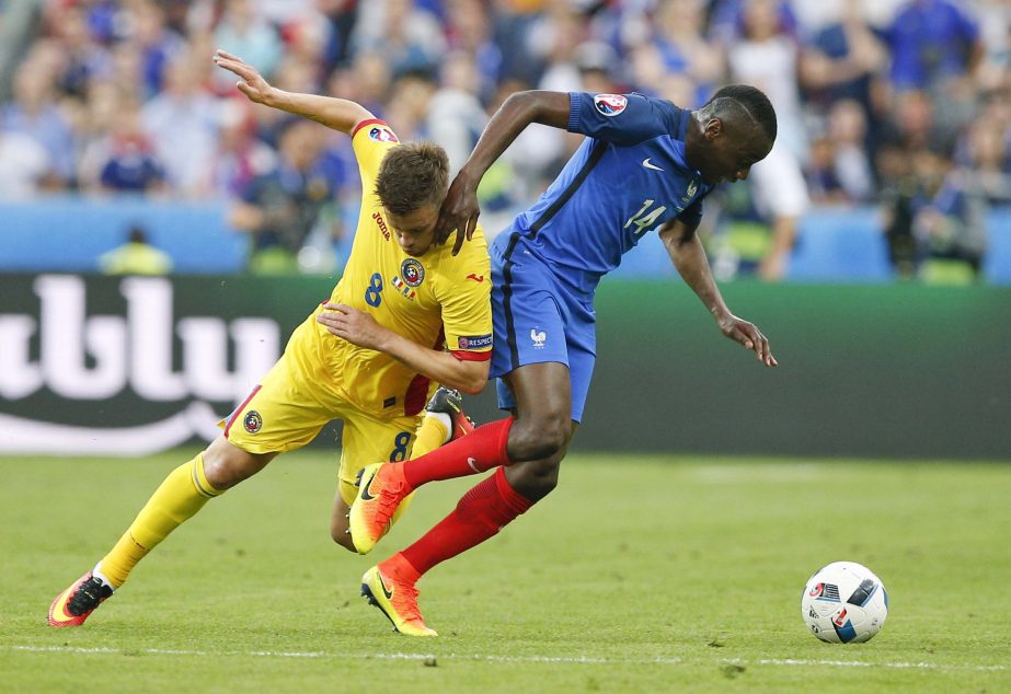 Romania's Mihai Pintilii (left) challenges France's Blaise Matuidi during the Euro 2016 Group A soccer match between France and Romania at the Stade de France in Saint-Denis, north of Paris on Friday.