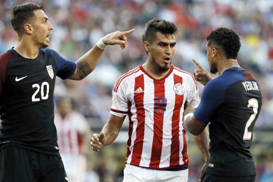 United States' Geoff Cameron (left) and DeAndre Yedlin (right) argue with Paraguay's Dario Lezcano after a tackle during the first half of a Copa America Group A soccer match in Philadelphia on Saturday. United States won 1-0.