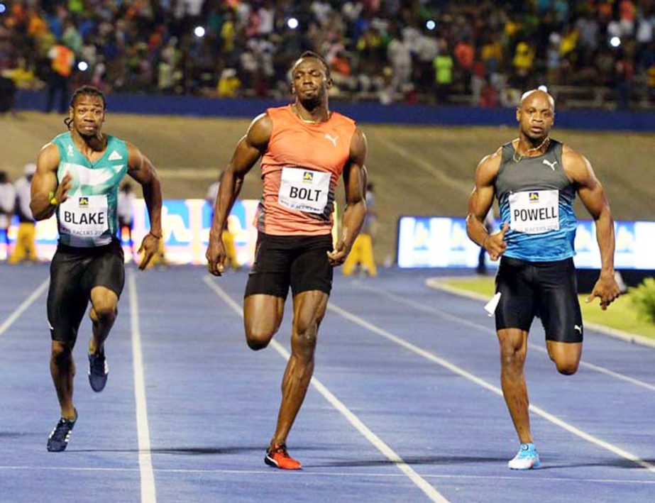 Usain Bolt (center) wins the 100-meter final ahead of Yohan Blake (left) and Asafa Powell in the Racers Grand Prix track and field event at the National Stadium in Kingston, Jamaica on Saturday.