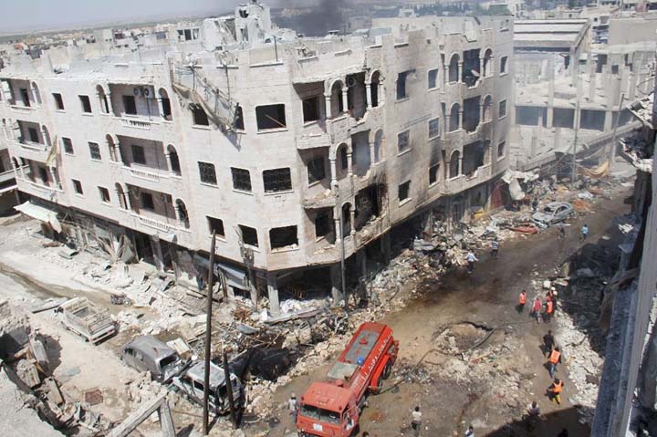 Syrian Civil Defence members, known as the White Helmets, gather at a site following air strikes on the rebel-held northwestern city of Idlib, on Sunday.