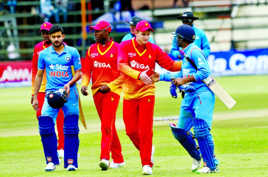 Zimbabwe and Indian cricket players shake hands at the end of the One Day International cricket match between the two teams at Harare Sports Club on Monday. The Indian crcket team is in Zimbabwe for One Day International and T20 matches.