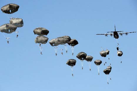 US troops land with parachutes at the military compound near Torun, central Poland, as part of the NATO Anaconda-16 military exercise.