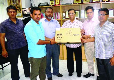 KHULNA: Sheikh Harun -ur- Rashid, Administrator, Khulna Zila Parishad giving a laptop to G M Nazmul Alam, Headmaster , Shahpur Girls' High School from the ICT Fund of Zila Parishad on Sunday.