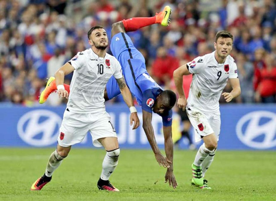 France's Blaise Matuidi (center) is airborne as he fights for the ball with Albania's Armando Sadiku (left) during the Euro 2016 Group A soccer match between France and Albania at the Velodrome Stadium in Marseille, France on Wednesday.