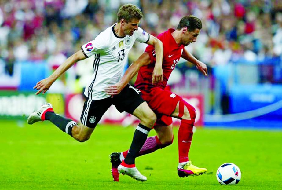 Germany's Thomas Mueller (left) fights for the ball with Poland's Grzegorz Krychowiak during the Euro 2016 Group C soccer match between Germany and Poland at the Stade de France in Saint-Denis, north of Paris, France on Thursday.