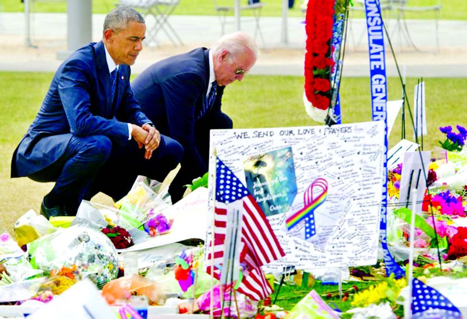 US President Barack Obama and Vice President Joe Biden place flowers for the victims of the mass shooting at a gay nightclub at a memorial in Orlando, Florida.