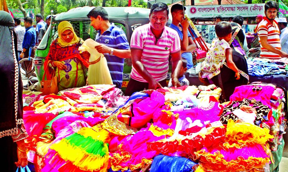 Low and middle income Eid shoppers crowded the footpath makeshift shops to buy readymade clothes and other essentials. This photo was taken from Bangabandhu Avenue area on Saturday.