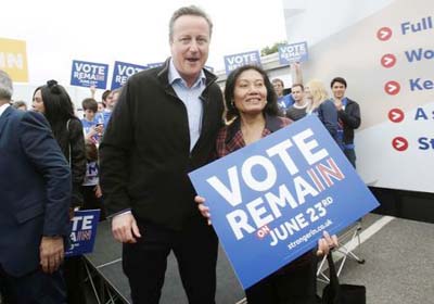 Britain's Prime Minister David Cameron poses with a campaigner as he makes a joint appearance with Mayor of London Sadiq Khan during their launch of the Britain Stronger in Europe guarantee card at Roehampton University in West London, Britain