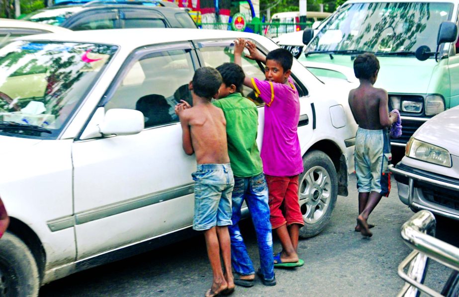 The children are hired for begging on the eve of Eid-ul-Fitr. This photo was taken from GPO area in the city on Sunday.
