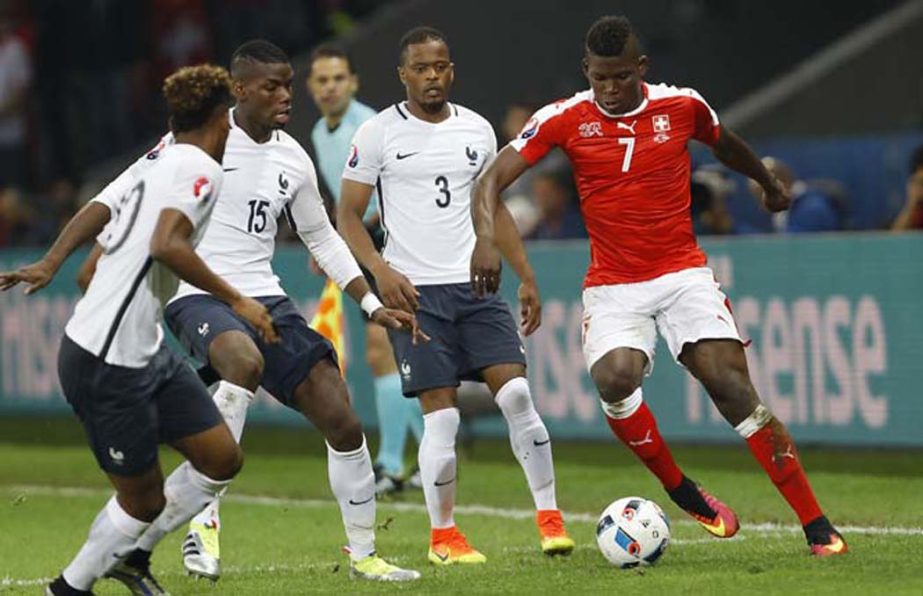 Switzerland's Breel Embolo (right) goes for the ball during the Euro 2016 Group A soccer match between Switzerland and France at the Pierre Mauroy stadium in Villeneuve dâ€™Ascq, near Lille, France on Sunday.